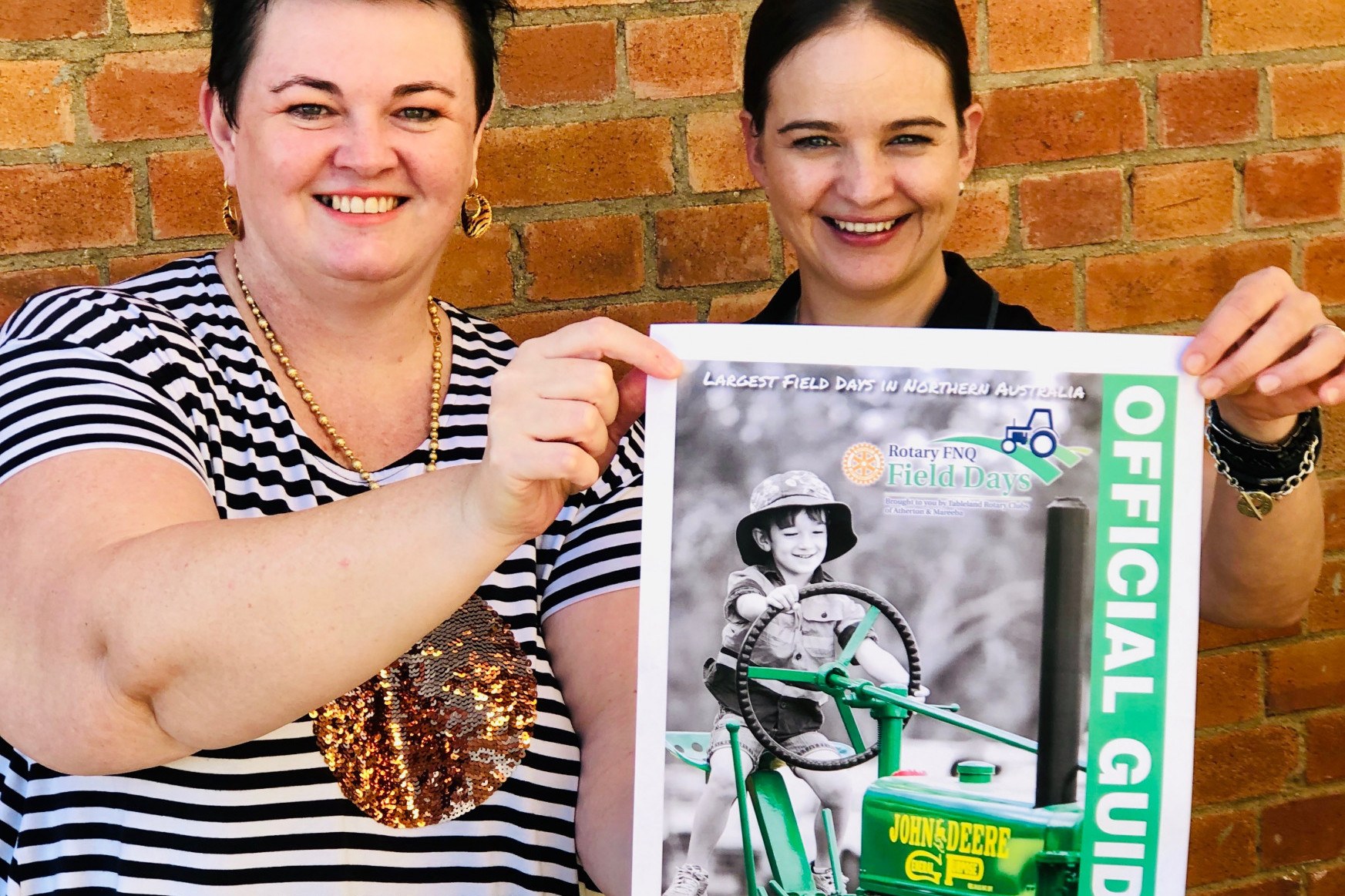 Rotary FNQ Field Days marketing coordinator Jeanette Sturiale and official guide coordinator Natasha Srhoj, with the winning photo that appeared on the cover of the 2019 offical guide.