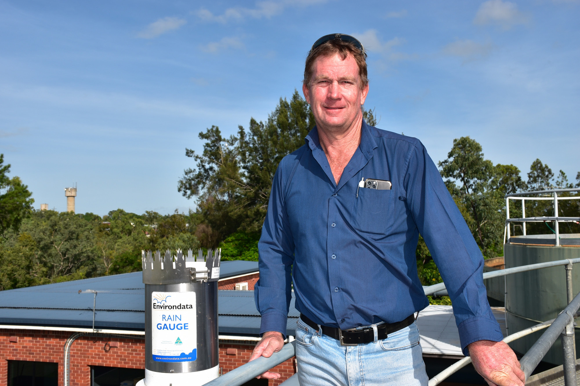 Mareeba Shire Council Deputy Mayor Kevin Davies with a rain gauge at the Mareeba Water Treatment Plant.