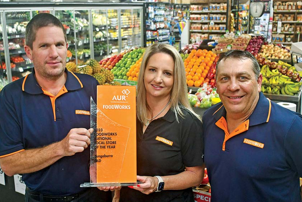 Store manager Tim Roberts with Yungaburra Foodworks owners, Kate and Phillip Mete celebrate the national award.