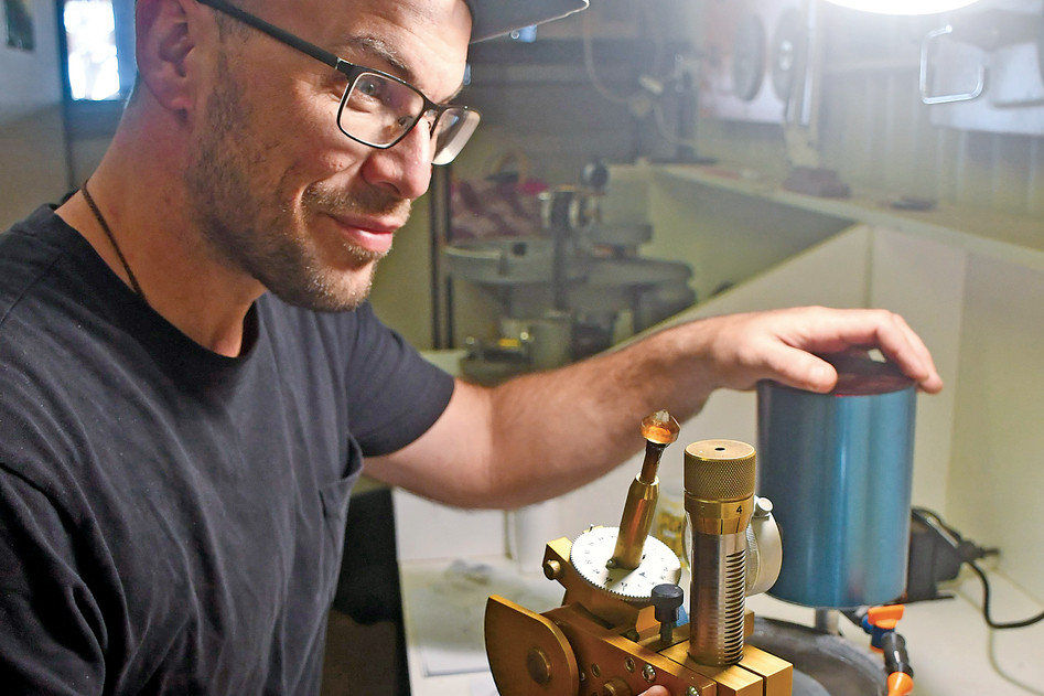 Sam Fogliaresi works with a rock fascinating machine to prepare for the Tolga Gem Festival.