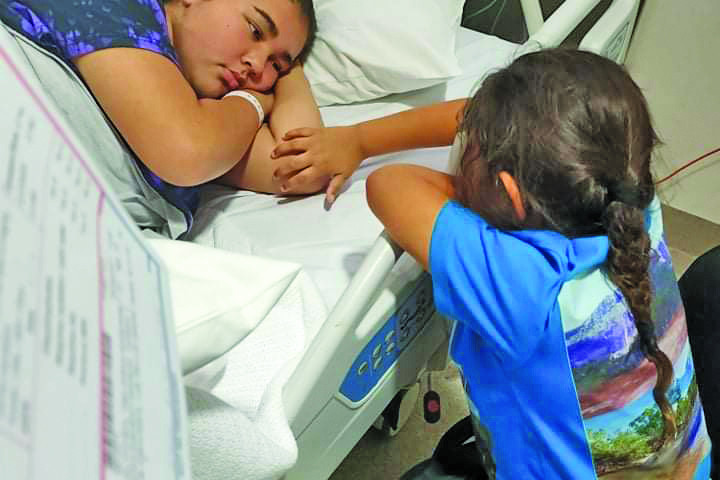 Mareeba girl Taejarna Gutchen pictured with her five year old sister Laysha in hospital.