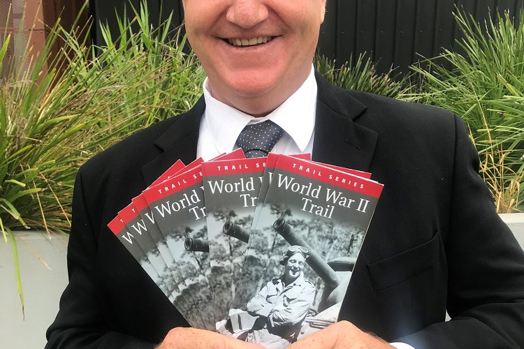 Cr Dave Bilney shows the new World War II trail brochure that has just been released.