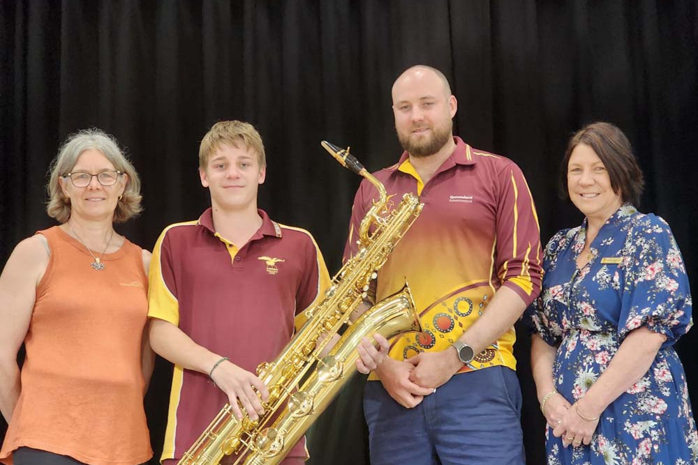 (from left) Dr Diana House from the Doctor House at Yungaburra, Atherton State High School Year 6 saxophone student Logan Brind-House, instrumental music teacher for the ATIM cluster Lachlan Szery, and high school principal Leanne Knight-Smith.