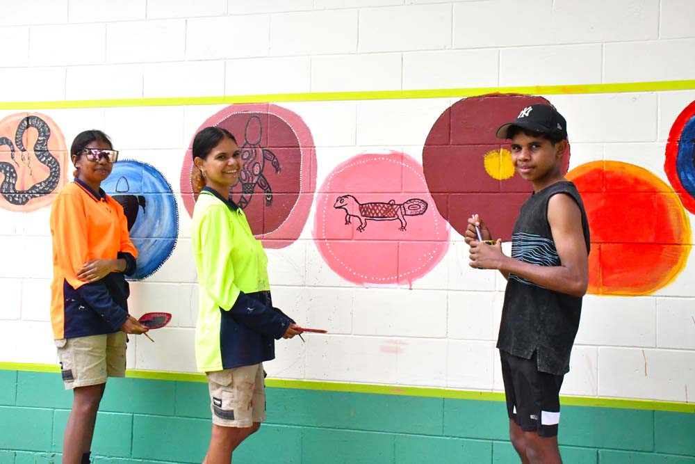 Asherah, Elizabeth and Edwin painting the outside of the Courtney Street Community Church as a part of the Skills 360 “Skilling Queenslanders for Work” course.