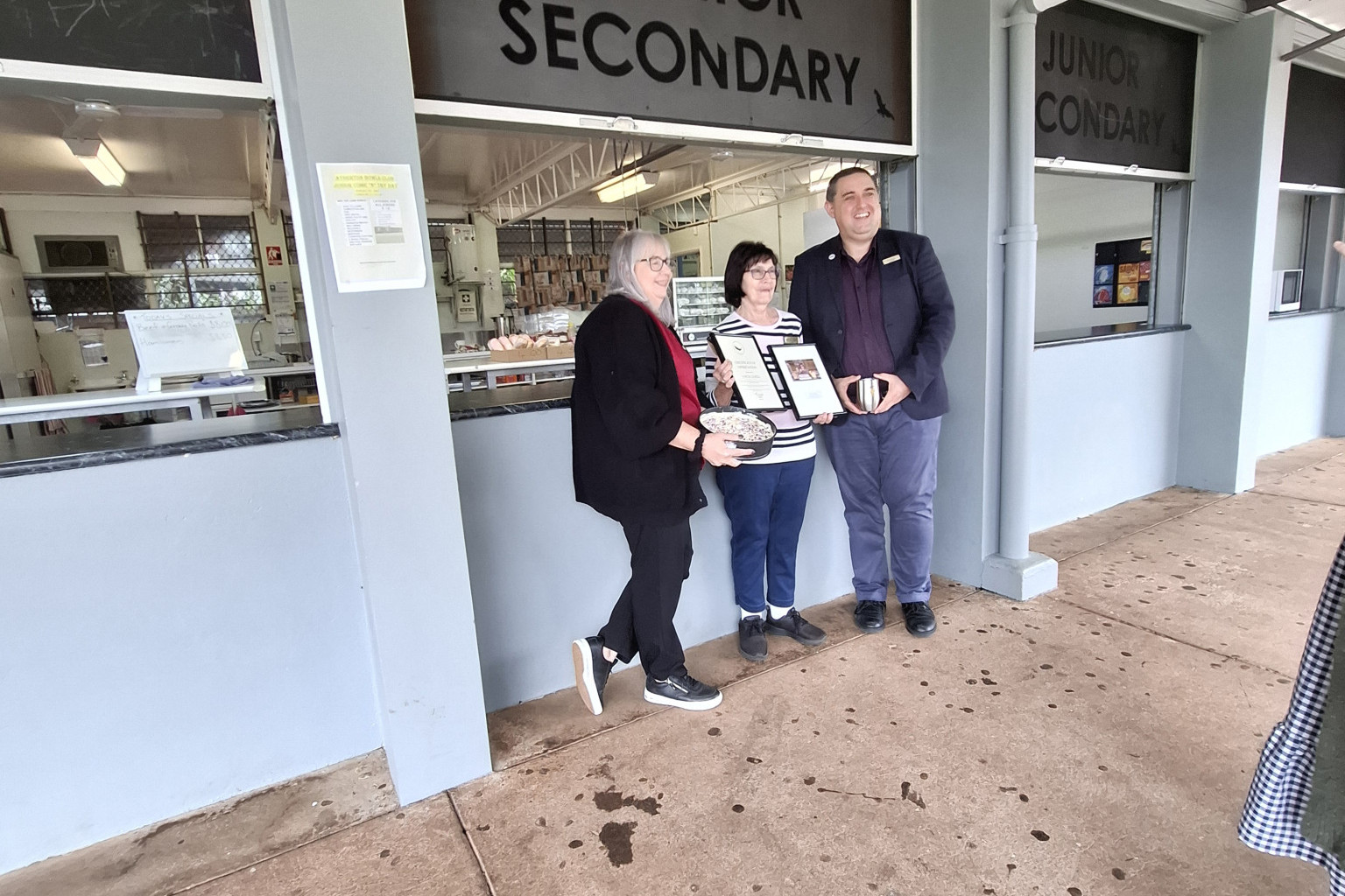 Joyce Cahill (centre) was recognised by the school last week, with a cake from office manager Kellie Harris and a certificate to make her 40 years’ of service from acting principal Chris Keating.