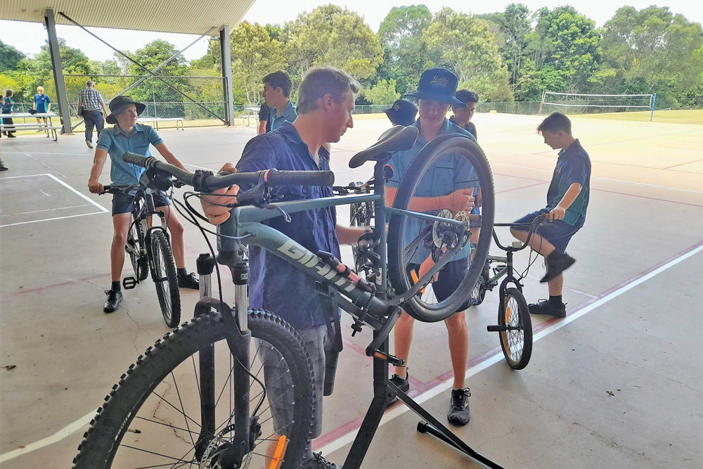 PICTURED: Doug from Bicycle Workshop Atherton inspecting student’s bikes before they hit the track