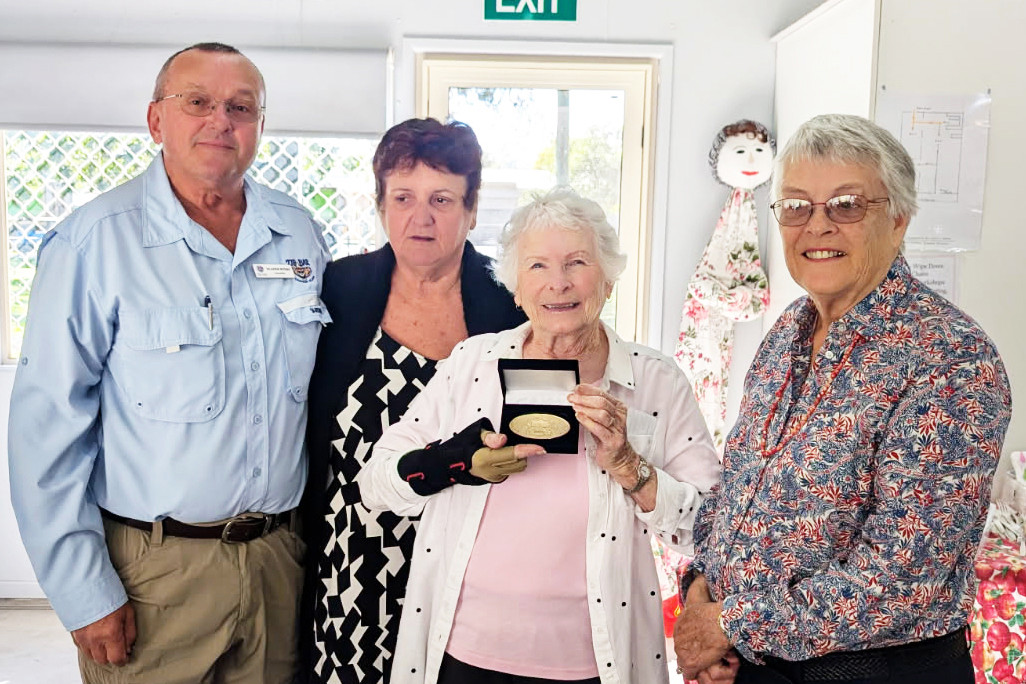 Historian Helen Kindt receives her Centenary Medal from Dr Ruth Kerr OAM. At the medal presentation were Mareeba Shire councillor Mladen Bosnic, Historical Society president Rekiba Krlzea, Helen Kindt and Dr Ruth Kerr OAM. (Inset): The Centenary Medal.
