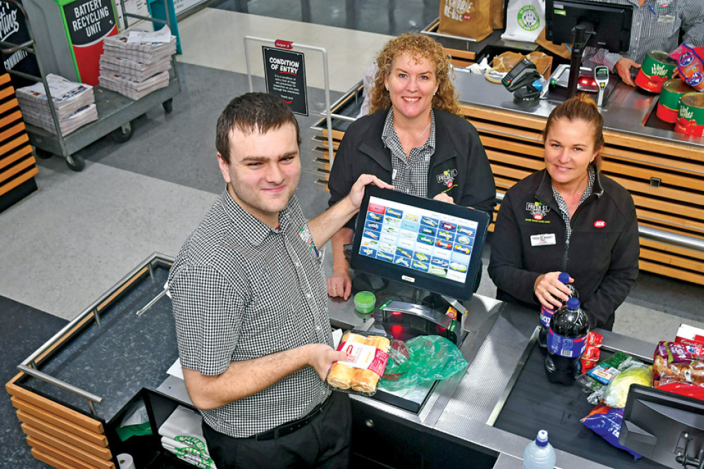 Kodi Buchanan has realised his dream of helping people in their everyday lives by working at Fresh St Market IGA, pictured with Human Resources manager Rachel Grandcourt and Customer Service manager Claire Maletz