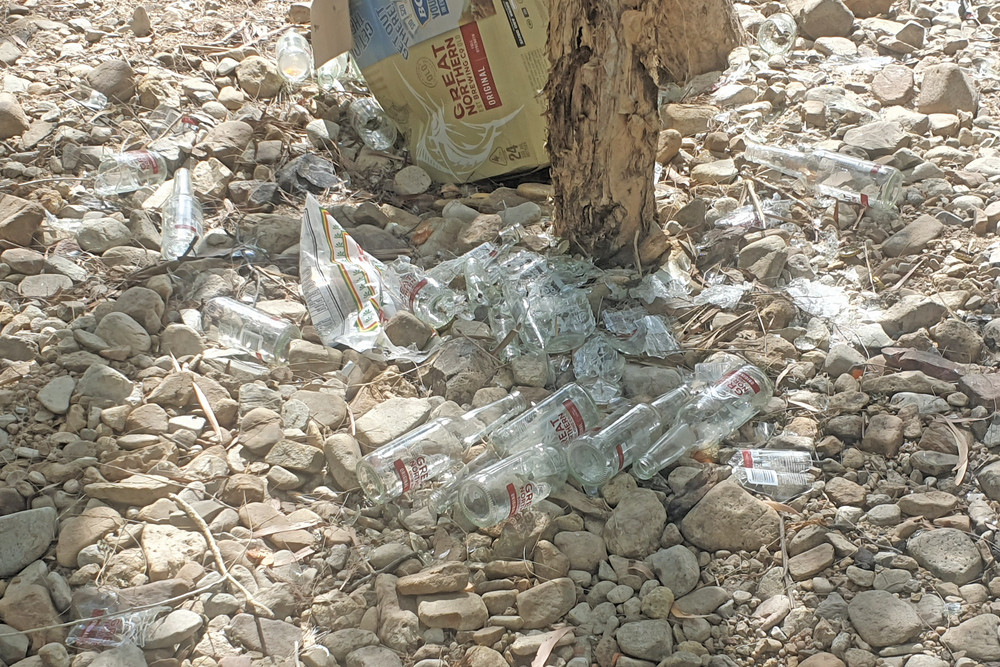 Bottles and broken glass at the Walsh River crossing on Pin Road near Mutchilba.