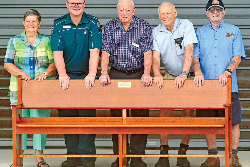Malanda Ambulance officer Shane Newton (second from left) with Cill Fry, Ted Rolley, Bob Barkworth and Jock Copeland who all had a hand in donating the refurbished church pew.