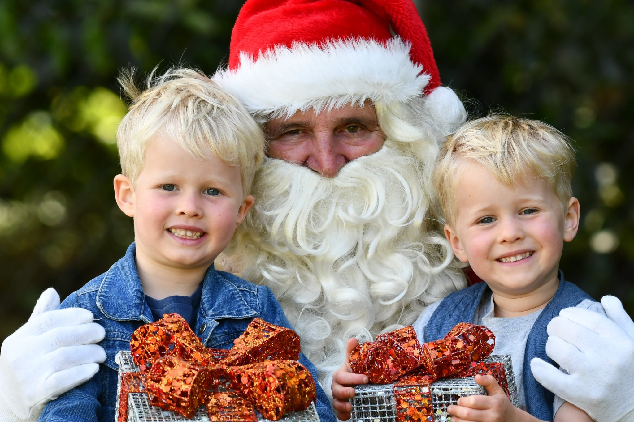 Santa and brothers Jack and Sonny Hawkins are looking forward to the 2023 Malanda Christmas Street Festival on 23 November.