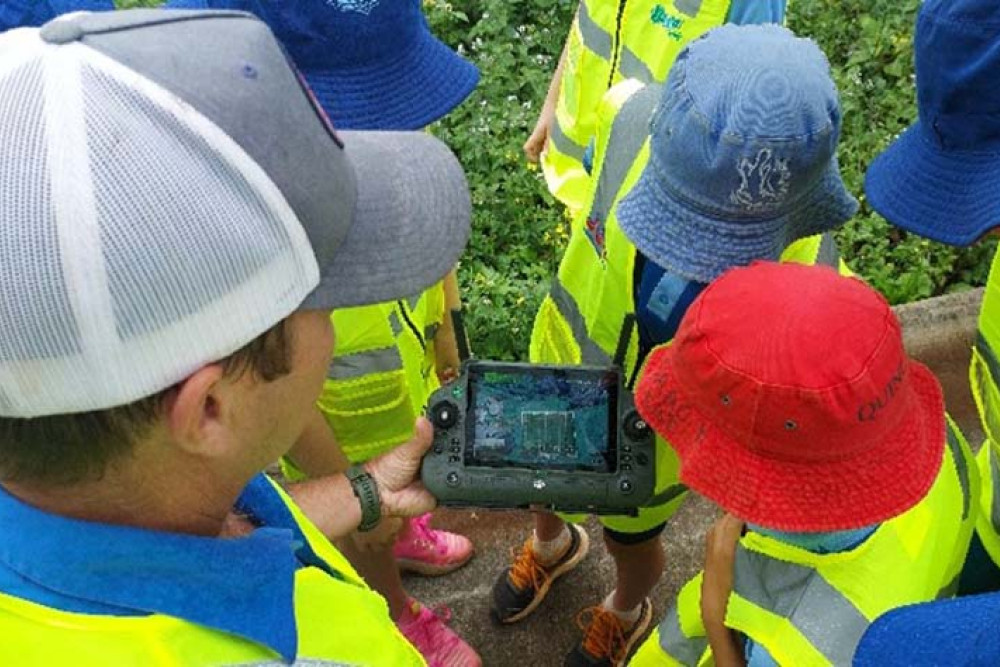 STEM students at Malanda State School being shown how to use a drone.