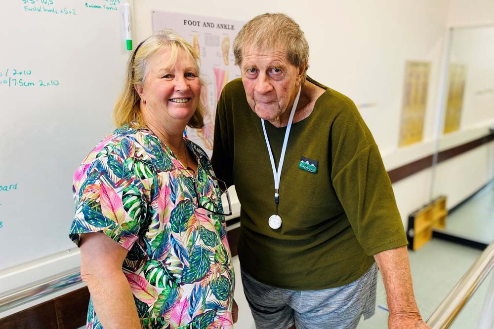 OPERA patient Earl Ross with allied health assistant Di Spencer in the new therapy room at Mareeba Hospital.