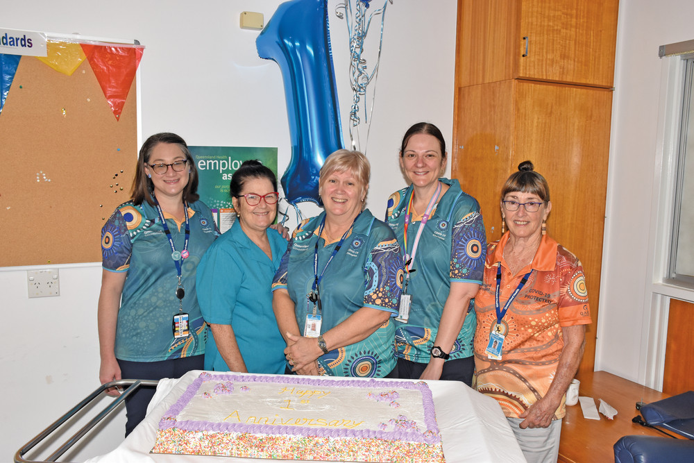 Mareeba Hospital allied and community health staff Amanda Turner, Glenda Fabris, Kate Buchanan and Cathie Archer with vaccination lead Diann Elliott (centre) celebrate the milestone with a special cake.