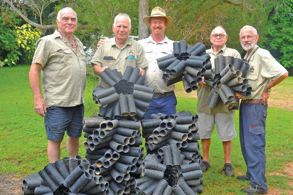 Mareeba Men’s Shed members Greg Sutton, Bob Archie, Terry Norriss and Cec Alayliffe with barramundi farmer Rodney Ingersoll with the red claw habitats they made.