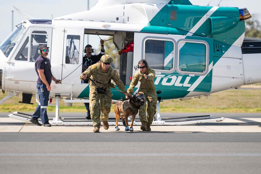 Mareeba man, Sergeant Duilio Di Pasquale (left, with Military Police Dog Doza, receives instruction from Corporal Jessica Baxter during the Military Police Dog Handler Course - Field Operations at Swartz Barracks, Oakey.