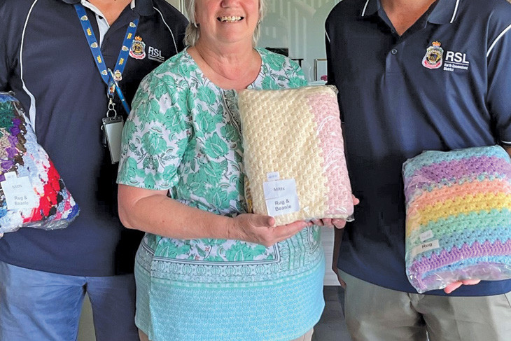 Members of Veteran Services Cairns Peter Blackwell and Greg Ludlow celebrating Operation Blankie with founder Margret Plant.