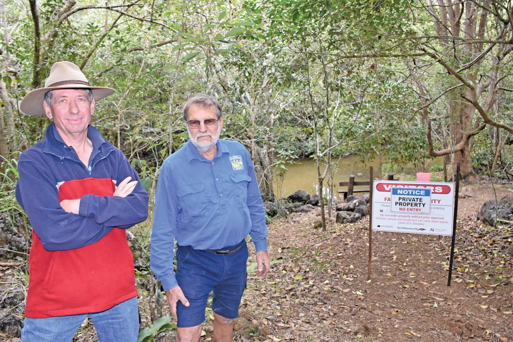 Local Rex Hutchison and Yungaburra Landcare volunteer Norm Bliesner in front of the sign erected on Petersen’s Creek.