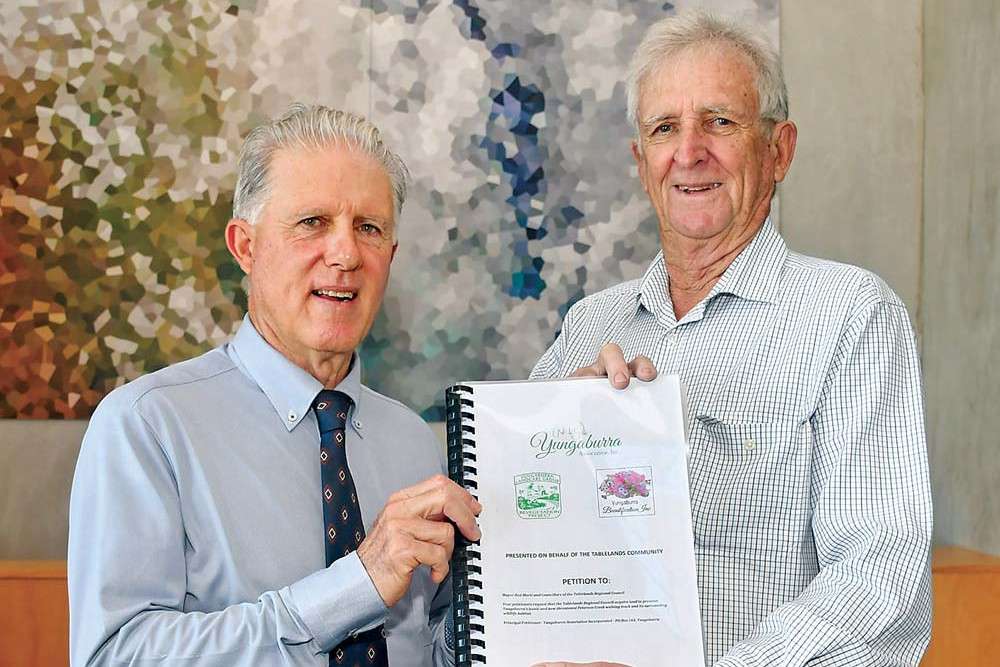 Yungaburra Association president Ken Jack handed the Peterson Creek Walking Track petition to TRC Mayor Rod Marti last week.