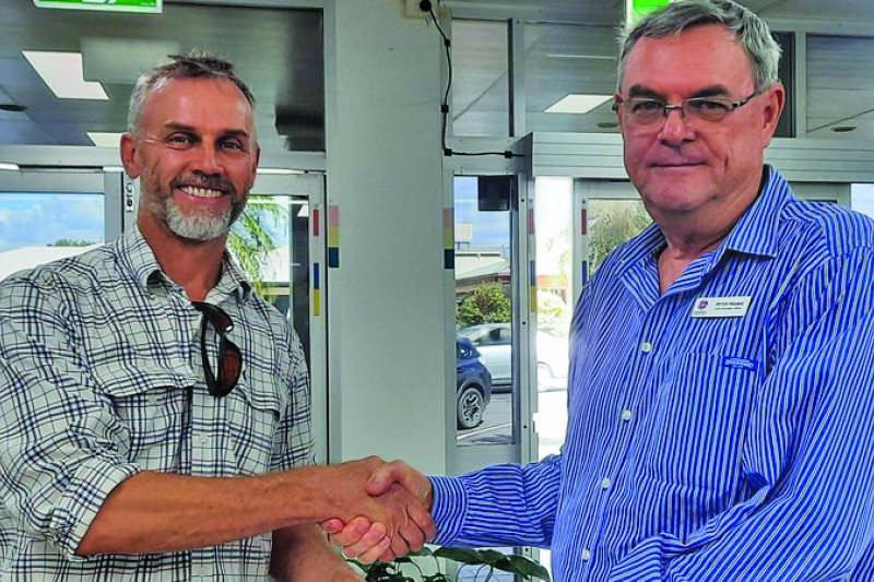 Businessman Fiachra Kearney (left) presents the 1481-signature petition to Mareeba Shire CEO Peter Franks.
