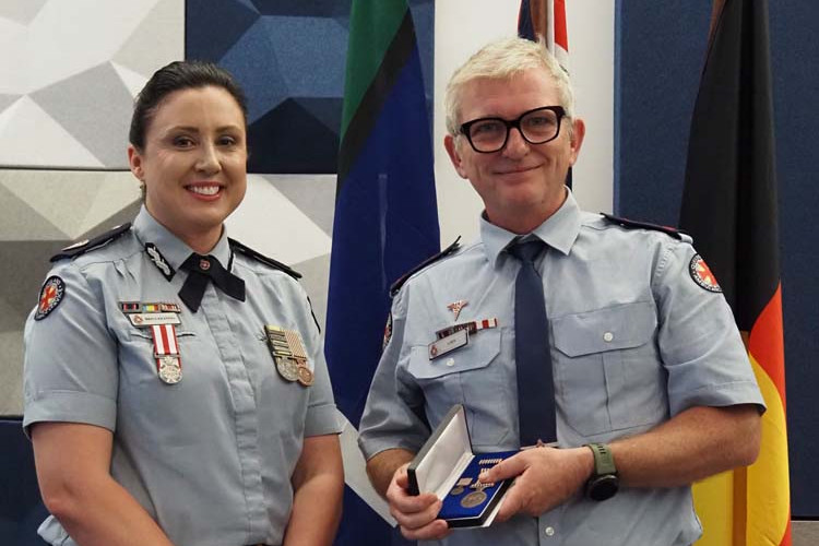 Dimbulah OIC Brendan Goldsworthy receiving his 20-year Long Service Medal from QAS Far Northern Commissioner Brina Keating.