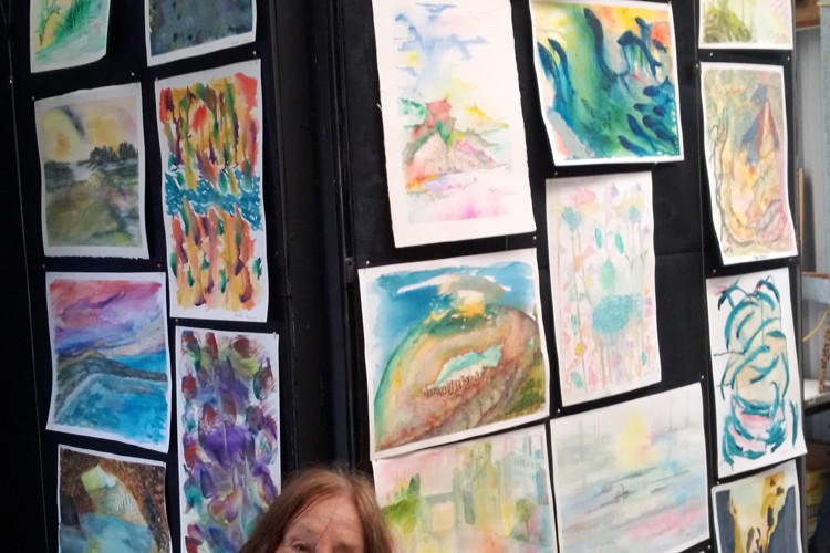 Elisa Wright with the Intuitive Painting display at the Ravenshoe Arts Shed