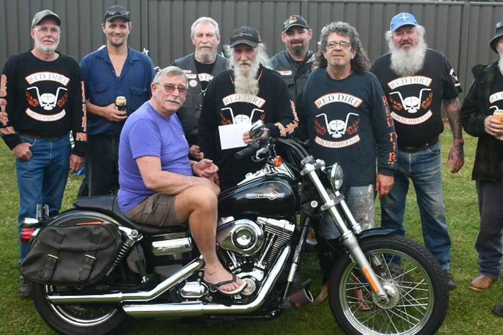 Red Dirt Bike Club donated $500 to Mac McCaul (on bike) who participated in the Relay for Life to honour his late wife.