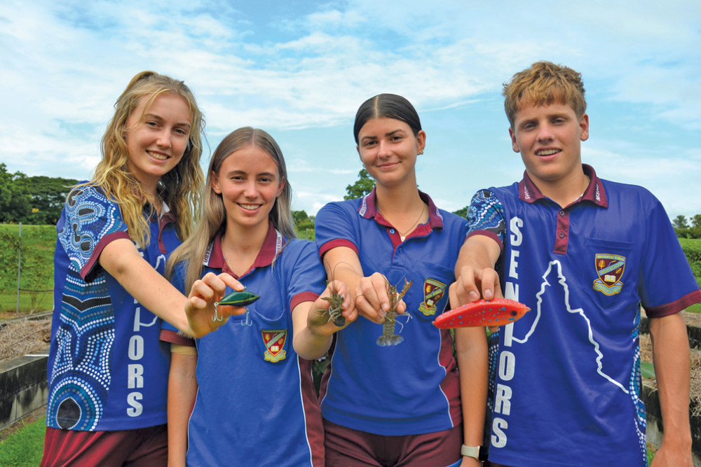 Cassia James, Taylah Nastasi, Kiralee Barter and Aiden Brown showcasing the red claw they are raising and the lures they have made in aquatic practices.