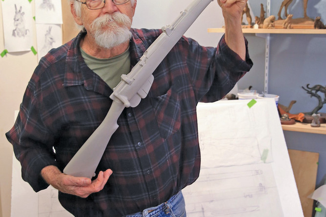 Internationally renowned sculptor Tom Tischler with the replica rifle he made for the Atherton Cenotaph.
