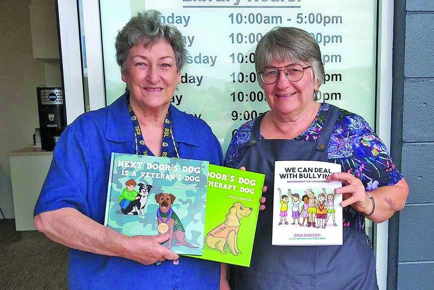 Mareeba RSL Sub Branch Secretary Cheryl Emmerson handing over books to Mareeba Library Assistant Delphine Brunjes.