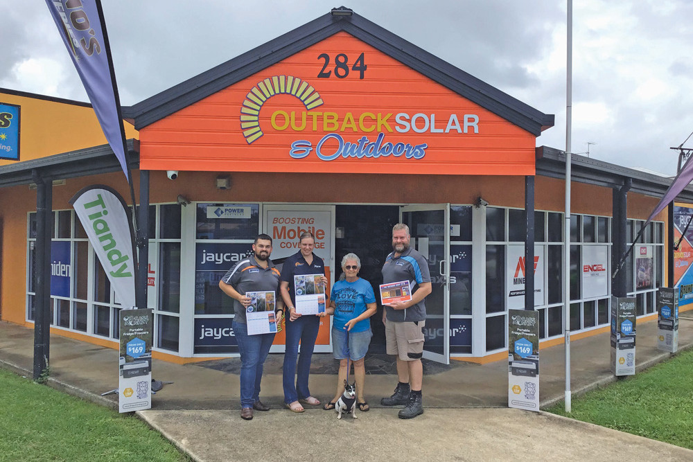 Outback Solar & Outdoors staff and Animal Rescue Tablelands’ Rena Braes with the calendars.