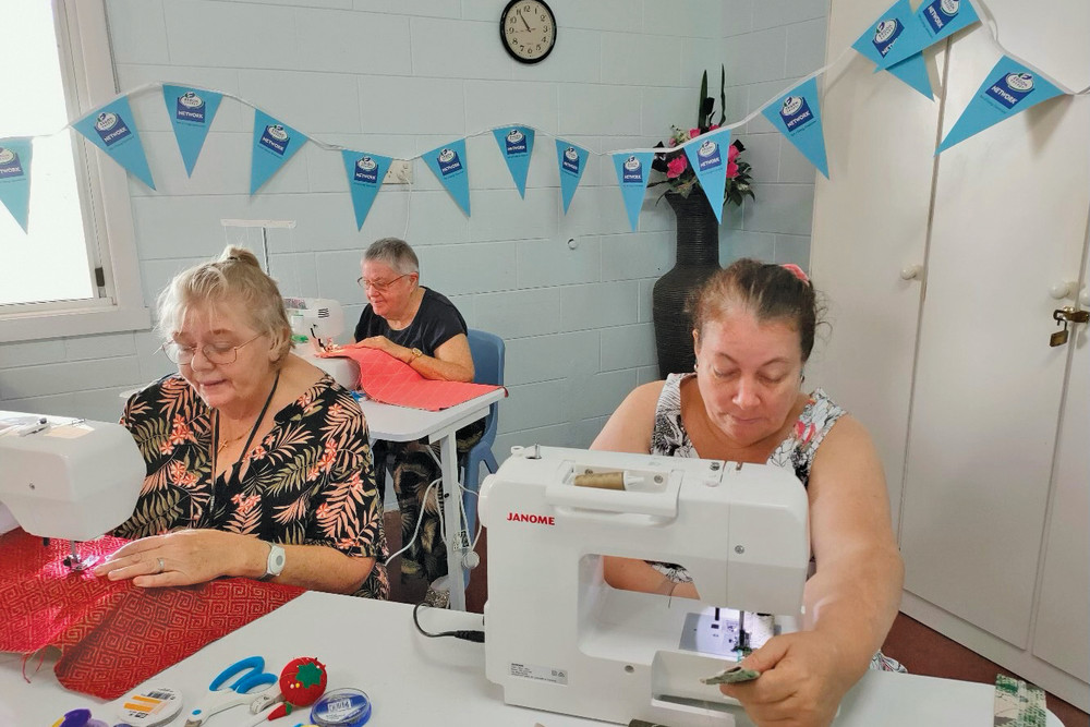 Mareeba QCWA members Donna, Pam and Rohan enjoying a morning of crafts with their new donated sewing machines.