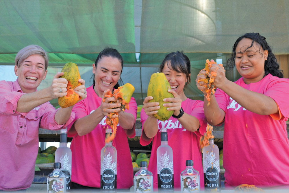 Skybury CEO Candy MacLaughlin with staff Sara Cioni, Erica Mori and Laina Liki squeezing the fresh papayas into Skybury’s award winning vodka.