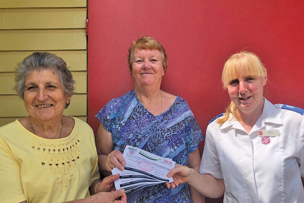 Soroptimist Club events coordinator Josie Raso (left) and treasurer Ann Rocca present the IGA vouchers to Miriam Newton-Gentle of the Salvation Army