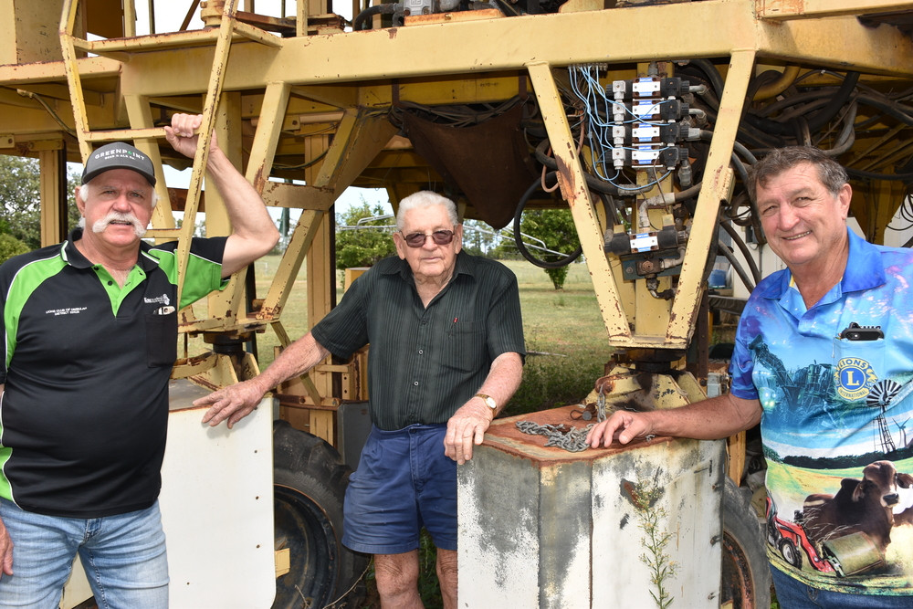 Mareeba Lions Club member Dennis McKinley, Dimbulah Lions Club member and donator of the tobacco picker Eddie Toffanelo with fabricator Brian Dunigan (centre) in front of the machine.