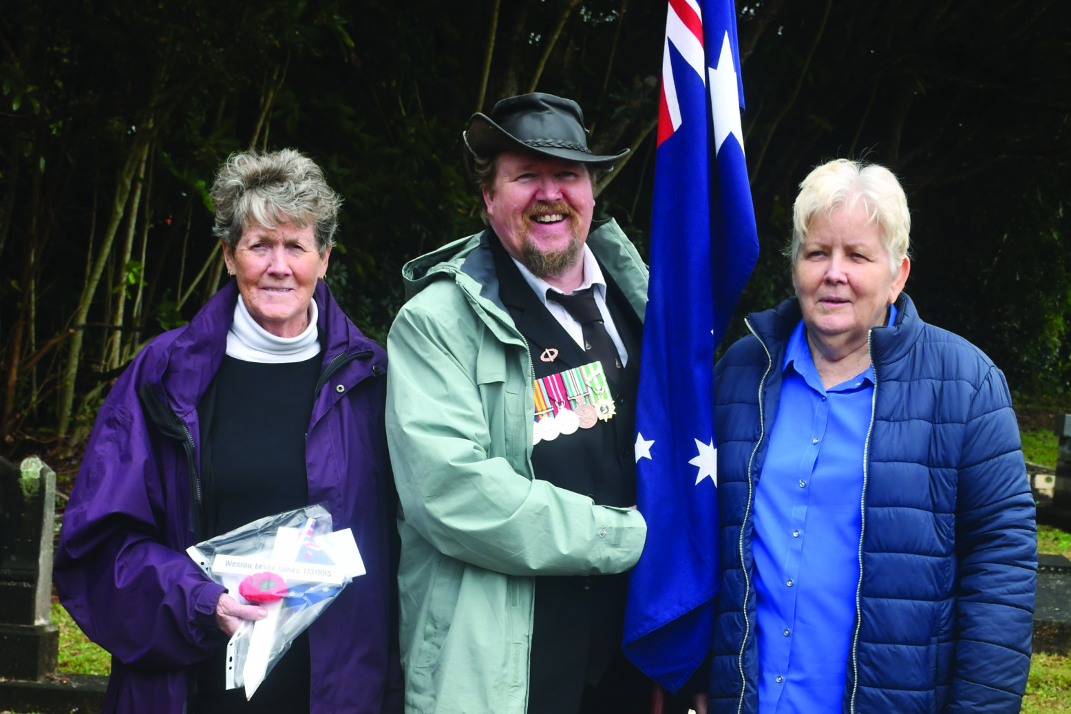 PICTURED LEFT: Gathered at the grave of Private Leslie James Weston on Thursday were his wife Diana (left), his son Paul, and his twin sister Lorraine Carrick.