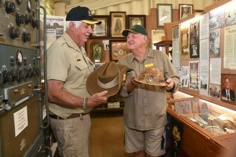 War tours guide John Hardy with Tolga Museum president Rob Fuller exploring some of the war history displayed in the museum.