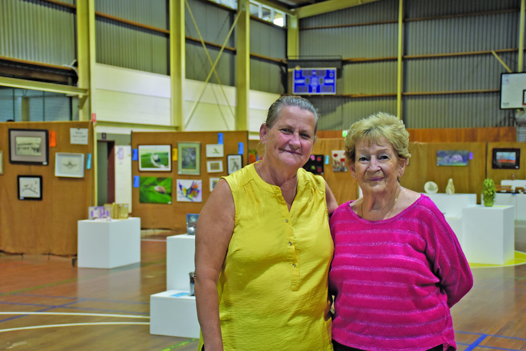 President of the Mareeba Arts Society Faythe Keogh and member Jan Bell setting up for the annual art exhibition in Mareeba.