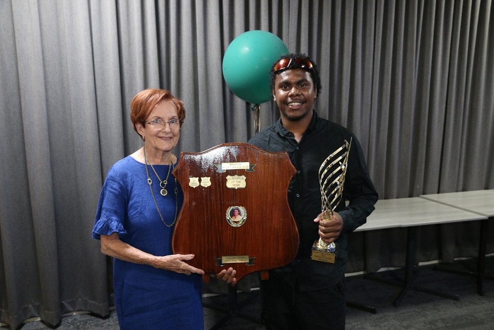 Pam Cater of Claude Cater Mensland presents Hubert Elu with his Gladiator of the Year award on Saturday night.