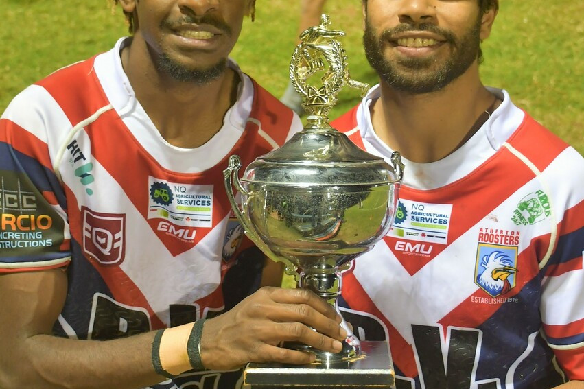 Debutant winger Alfred Passi and fullback Ty Grogan with the Tableland Cup after the Roosters win on Saturday night.
