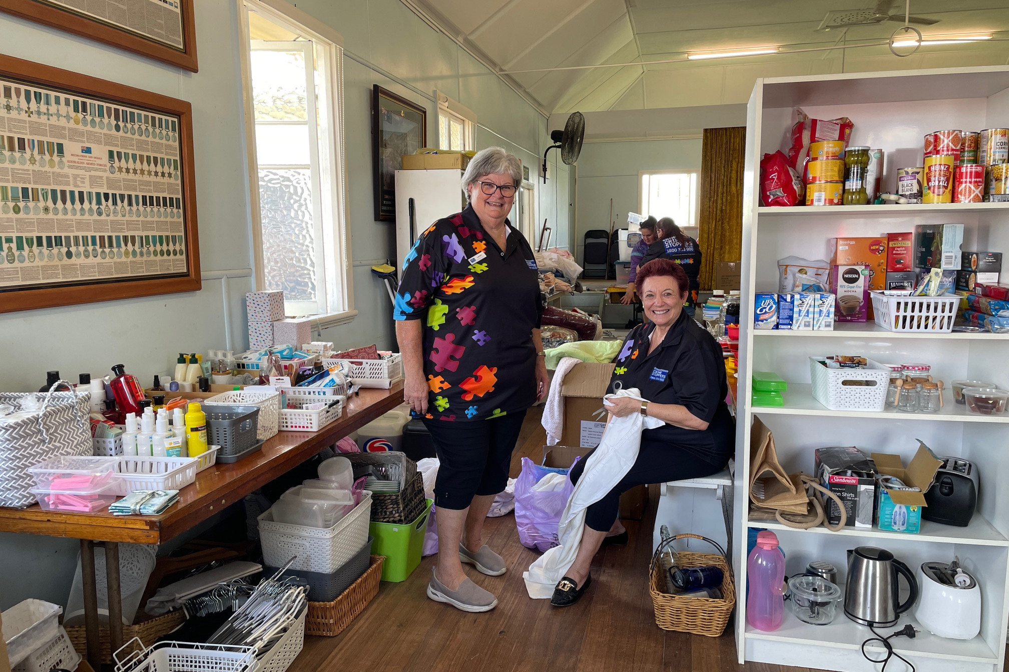 Mayor Angela Toppin and volunteer Carmel Pedron (left) help out at the hub which is assisting flood victims.