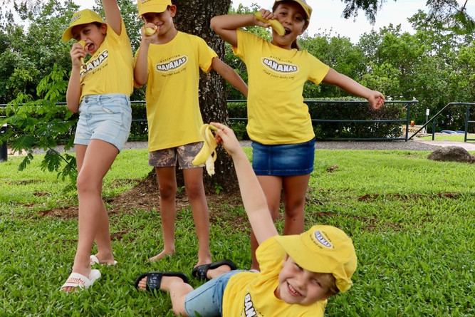 Banana farming kids from left to right Isadora Nucifora, Brandon Borsato, and Gabriella and Teodoro Nucifora, tuck into Australia’s favourite supermarket fruit.