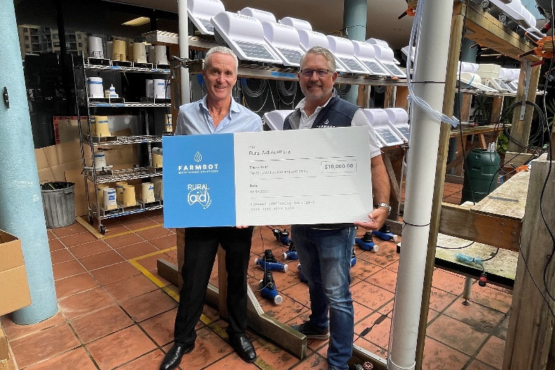 Rural Aid CEO John Warlters (left) and Farmbot managing director Andrew Coppin with the $10,000 donation cheque.
