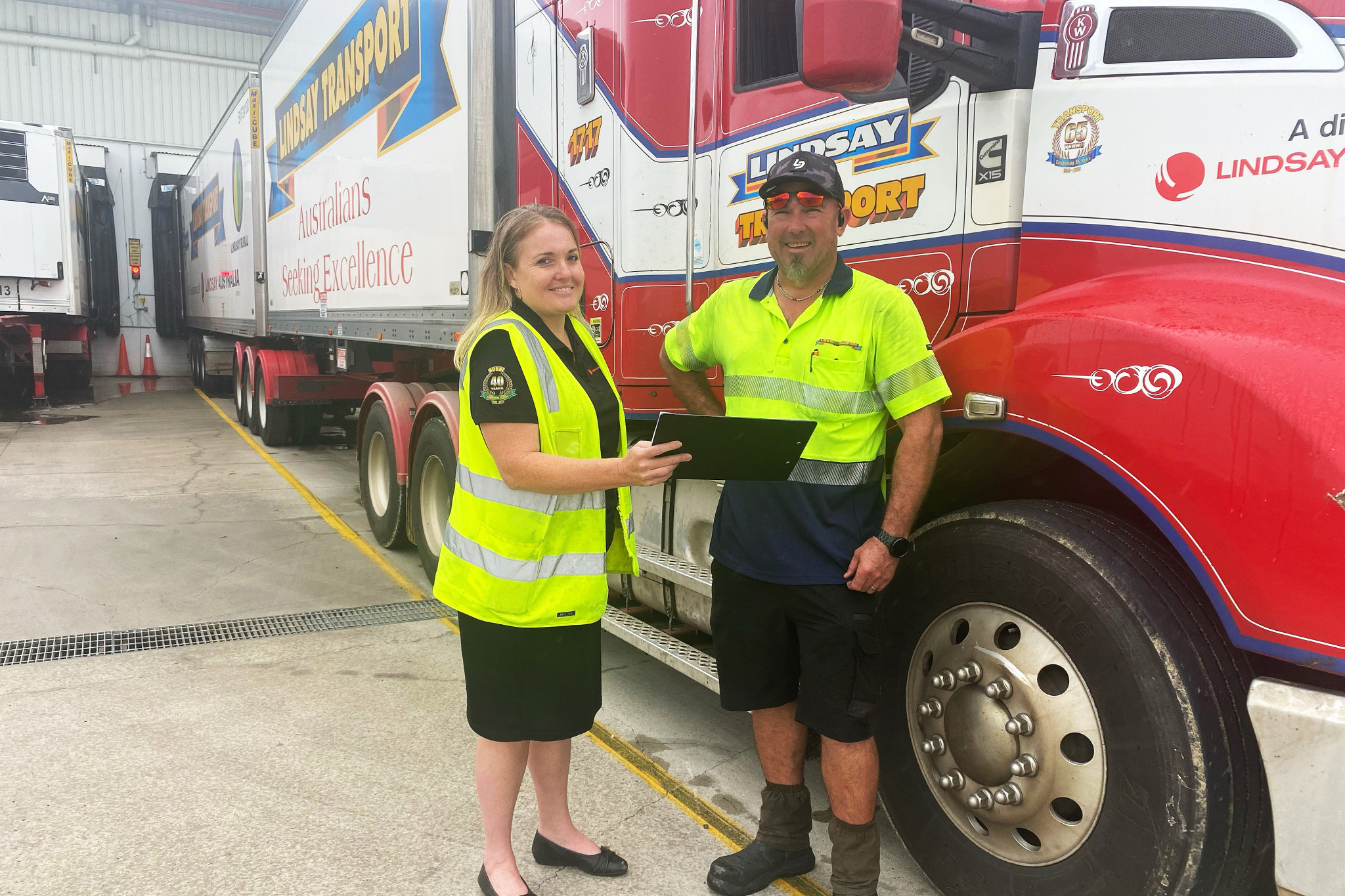Lindsay Transport Mareeba depot manager Julia Ninness and driver Ebbie Swemmer discuss the details of yet another Linfox B double laden with local farm produce for southern markets.