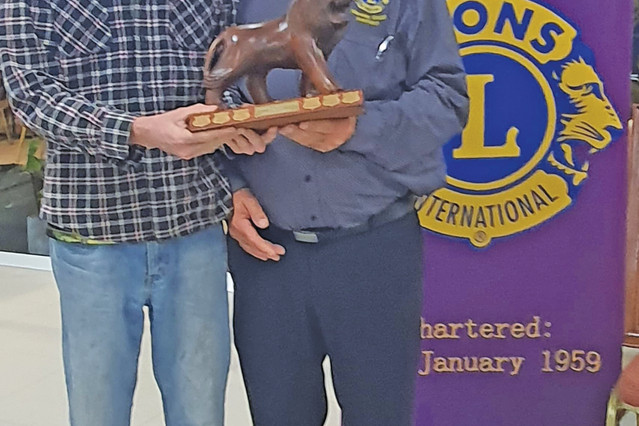 Mareeba Lions president Ricco Cabassi presenting vice president Justice Eales with the 2021-22 Lion of the Year award