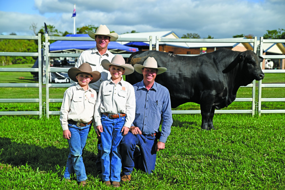 Lindsay Barlow and sons Braden (7) and Declan (9) alongside Stephen Pearce of Telpara Hills in Tolga after a successful purchase of a bull at the recent sale.