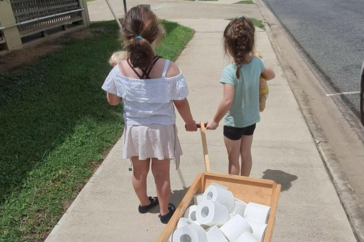 Loaded with toilet paper two little girls visit local pensioners. - feature photo