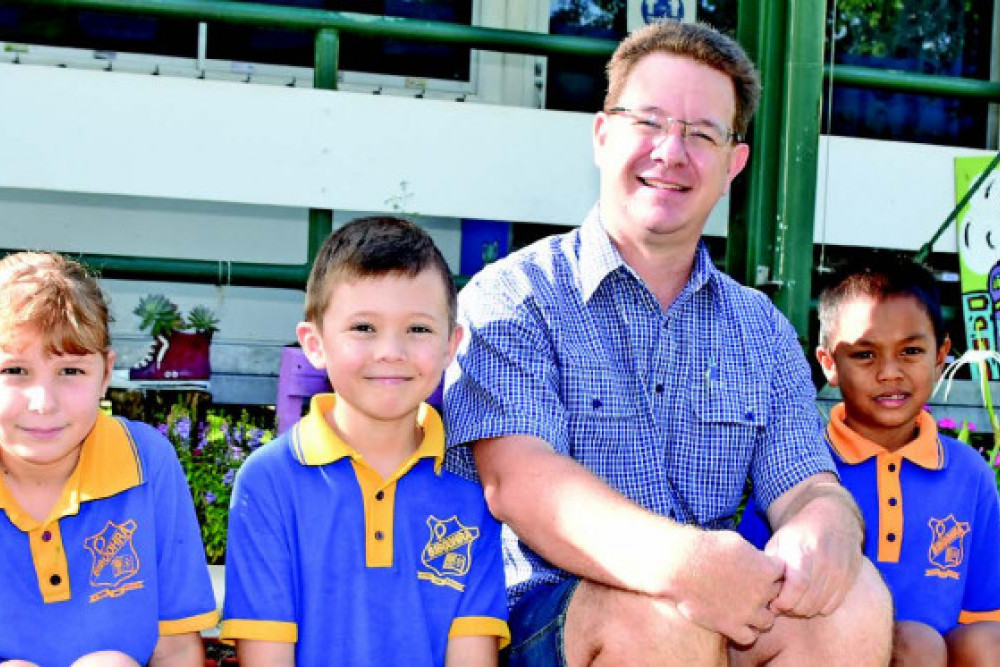 Amelia Hill (grade 4), Ben Foster (grade 3) and Sorrasak Fisher (grade 2) with Principal David King on their first day back at Biboohra State School on Monday.