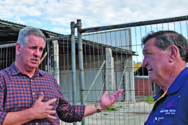 Shadow Minister for Police and Corrective Service Dale Last speaking with Denis McKinley outside the burned out old Performance Motors building in Byrnes Street.