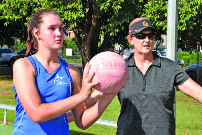 Australian netball legend Vicki Wilson running through a drill with Mareeba Netball player Isabella Teasdale during the recent Marlin Coast Netball selection clinic on Friday.